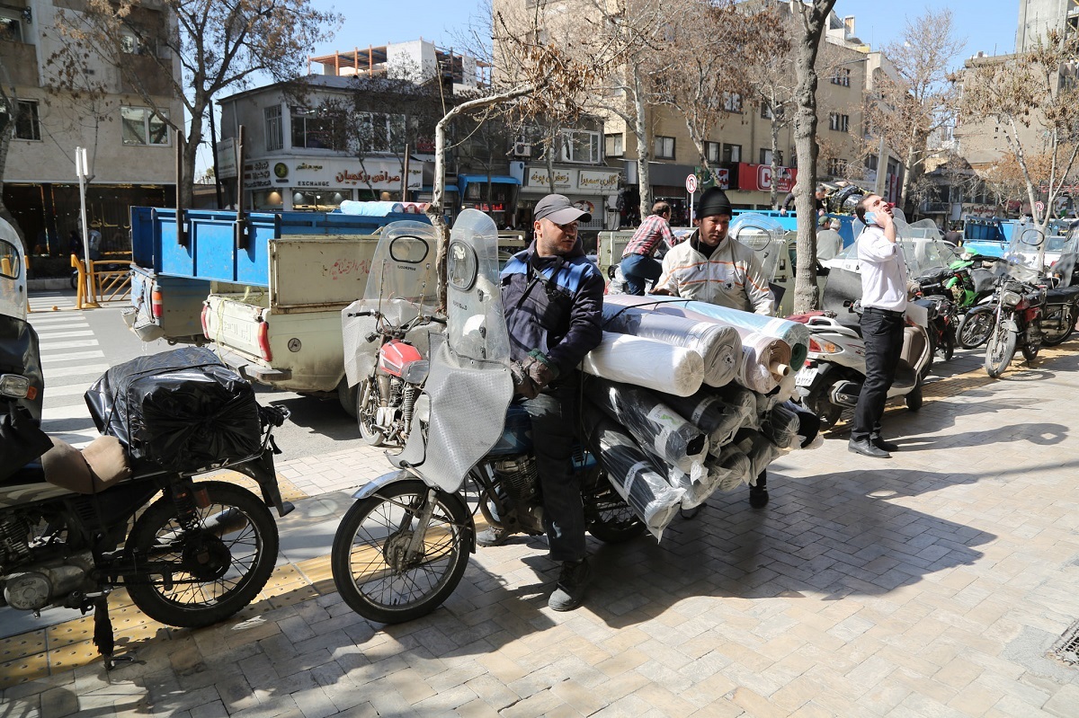 باربران موتورسوار خیابان شهید اندرزگو روزانه صد‌ها کیلوگرم پارچه را جابه‌جا می‌کنند